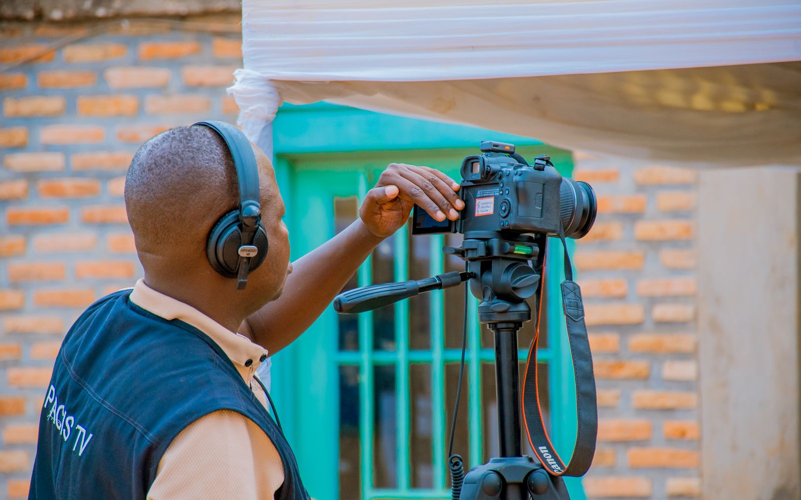 Camera operator filming with professional equipment